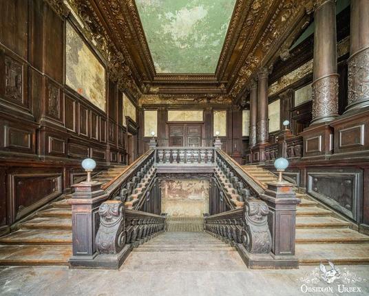 photo of grand stairs, all out of carved wood. this is clearly a grand house or palace