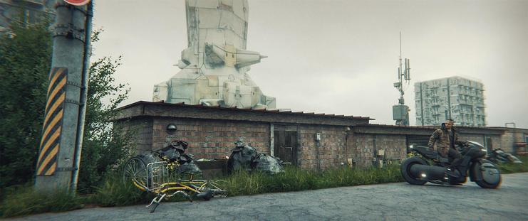 Wide shot, exterior, day -

A row of old storage sheds amidst even older, soviet-era dormitories. In the background, a regional CST can be seen.  A man on a motorcycle waits on the road in front of the storage units.