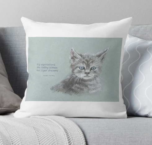 Throw pillow featuring the haiku 
big aspirations
the tabby kitten
has tiger dreams

combined with the 'Cute little cat' pastel painting in landscape format painted by the artist Karen Kaspar. The picture shows the head and upper body of a cute little grey tabby cat on a grey-blue background. The kitten looks curiously towards the viewer with its blue eyes.