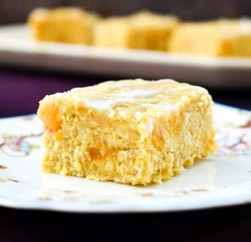 Apricot and coconut oat bar topped with a drizzle of icing.