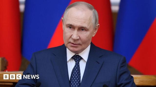 Russian President Vladimir Putin, wearing a navy blue suit and tie delivers a speech during a meeting of the Presidium of the Council of Legislators of Russia at the Tauride Palace in St. Petersburg, Russia, 28 April
